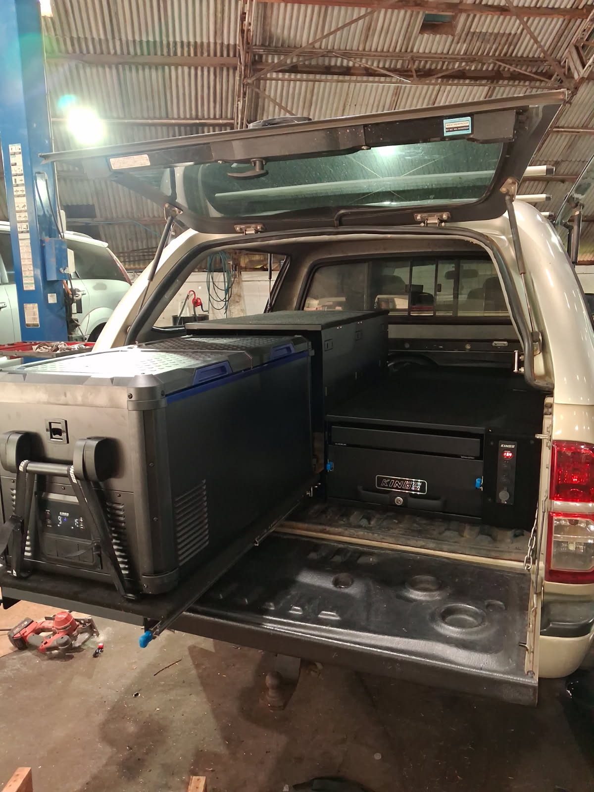 A 4WD touring fitout with fridge slide and drawers, built at the Nixon Auto Electrics workshop in Atherton